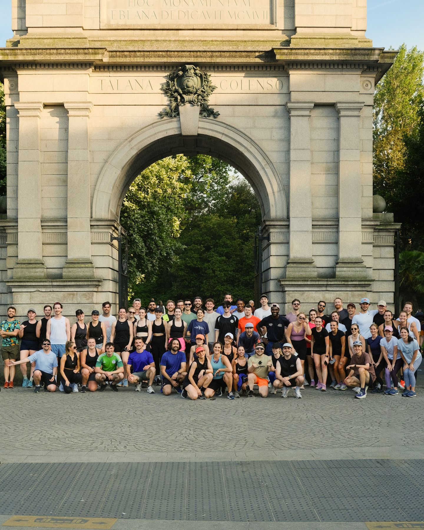 The whole club posing for a group photo in front of Fusiliers' Arch.